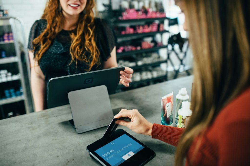 A Woman Swiping a Card on a POS System