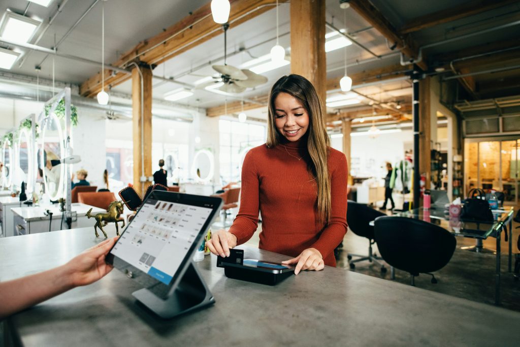 A Woman Swiping a Card on POS Credit Card Machine