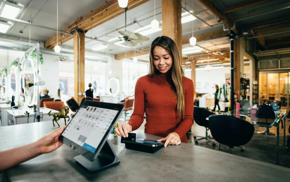 A Woman Swiping a Card on POS Credit Card Machine