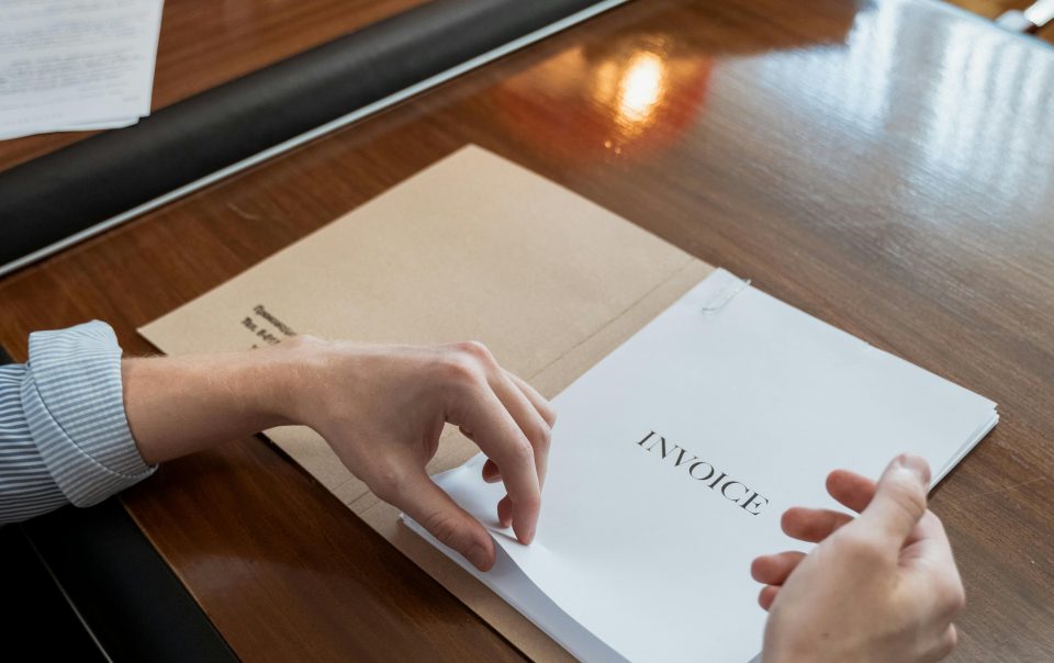 A Person Holding an Invoice Documents